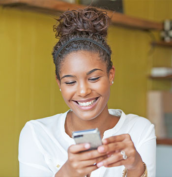 Woman looking at her phone and smiling